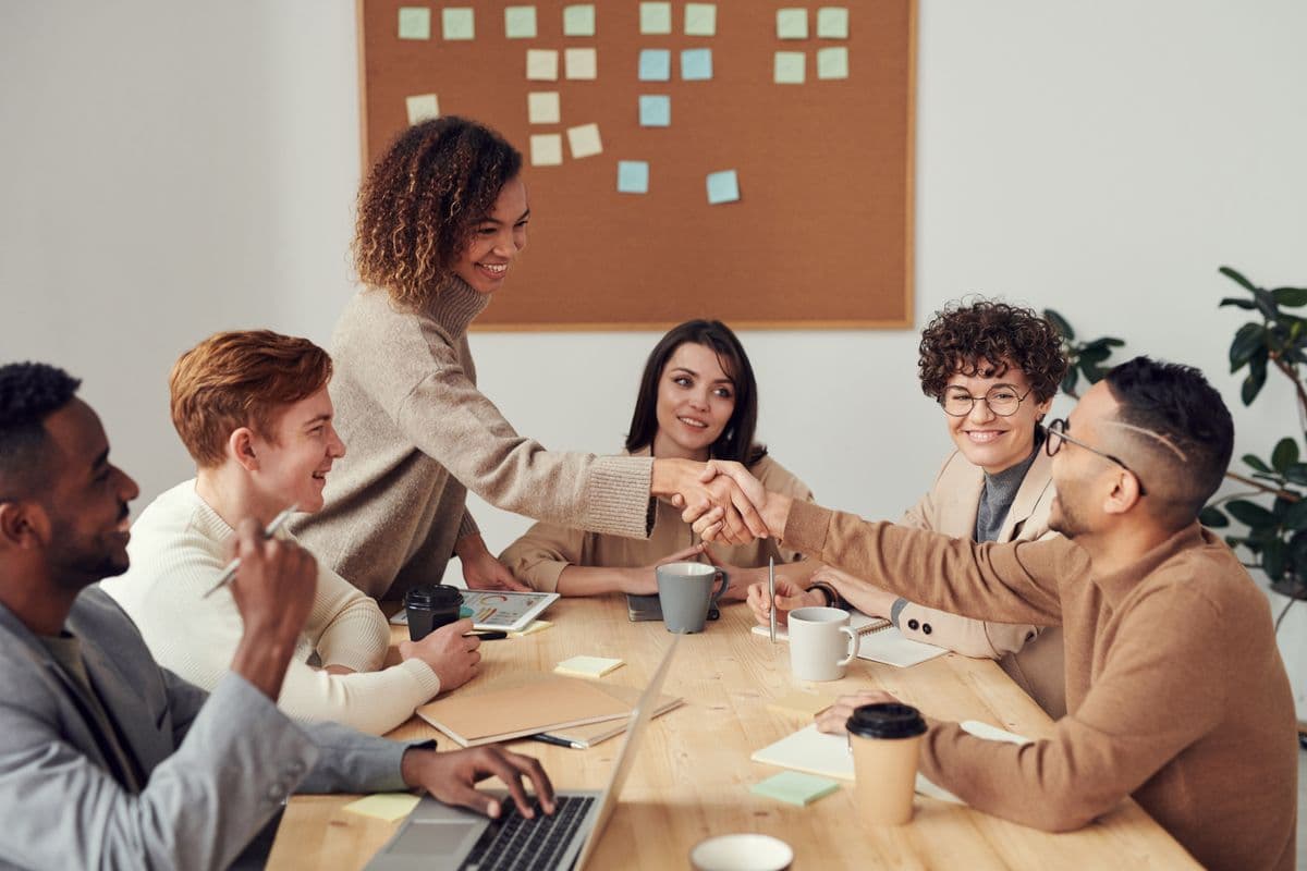 Two parties closing a deal across a boardroom table